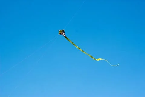 Flying kite in blue sky Stock Photos