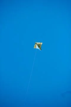 Flying kite in blue sky Stock Photos