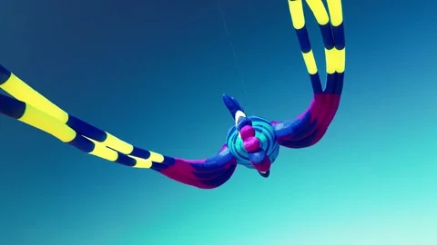 A flying kite in the shape of a sea fish against a blue sky at sunset on a sunny Stock Footage 241516192
