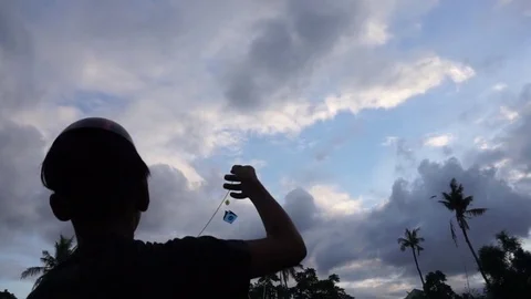 Flying a kite silhouette 動画素材 77704419