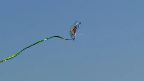 Flying a kite in strong wind on blue autumn fall sky 4K Stock Footage 102595624