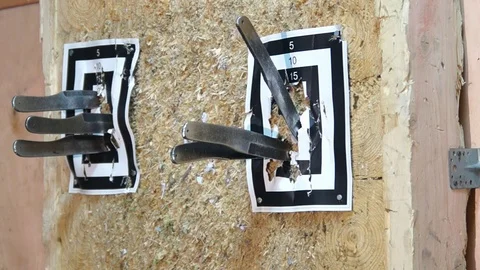 Flying knife. Man is throwing knife. Tournament. Knife throwing. Throwing nail Stock Footage 89323671