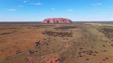 Flying to large red sandstone monolith Uluru also known as Ayers Rock, Australia Stock Footage 278095015