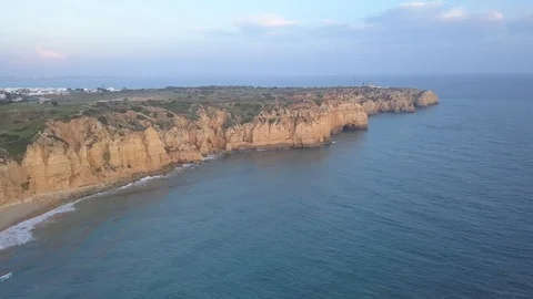 Flying left over cliffs and ocean at dusk with soft light. Stock Footage 98400909