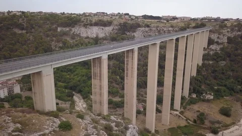 Flying left over roadway of Modica viaduct Stock Footage