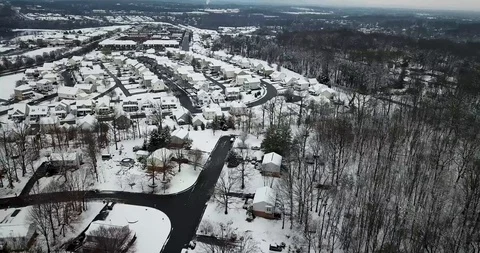 Flying to the Left Over Snow Covered Town Stock Footage