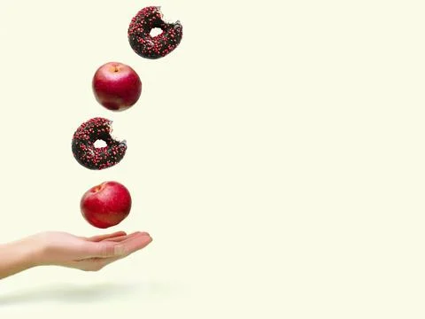 Flying levitating floating red ripe fresh apples with sweet glazed doughnut.. Stock Photos