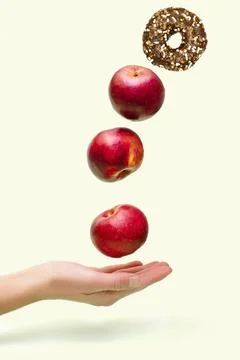 Flying levitating floating red ripe fresh apples with sweet glazed doughnut.. Stock Photos