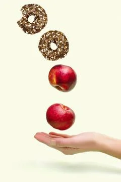 Flying levitating floating red ripe fresh apples with sweet glazed doughnut,d Stock Photos