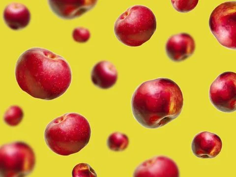 Flying levitating floating red ripe fresh juicy apples in air on yellow bac.. Stock Photos