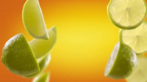 Flying of Lime and Slices in Orange Background Stock Footage 123503496