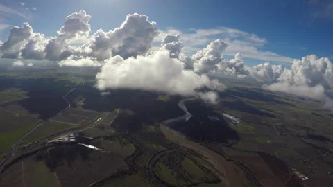 Flying up to lone cloud over agricultural lands northern California Stock Footage 240416248