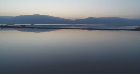 Flying low above the Dead Sea at sunrise 4K Stock Footage 106340409