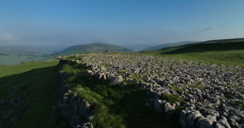 Flying low above limestone pavement in Yorkshire Dales Stock Footage 277250648