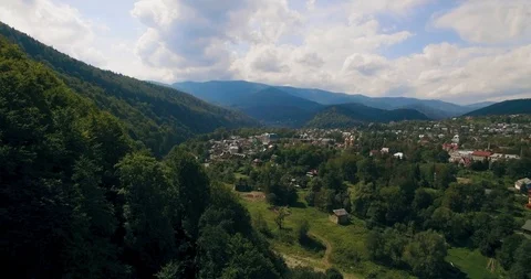 Flying low above the river carving its way through the spring valley. 4k Stock Footage 109802460