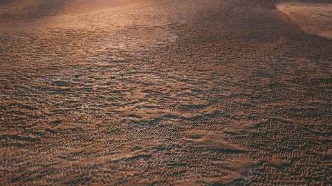 Flying low above sandy beach towards sunset Stock Footage 90758383