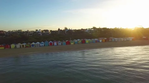 Flying low above water parallel to Brighton Beach bathing huts facing sun Video stock 70082582