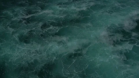 Flying low above the waves, camera panning up from the sea 스톡 동영상 77508118