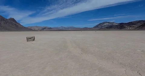 Flying low along sliding rocks at Racetrack Playa, Death Valley, CA Stock Footage 72961534