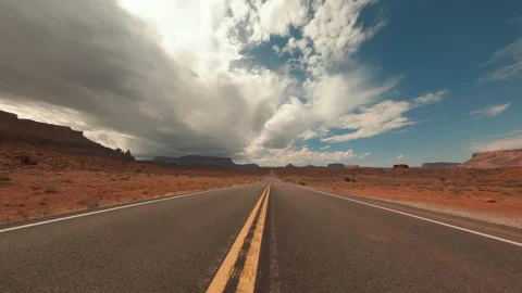Flying low and fast along two lane spectacular scenic desert road in Utah Stock Footage 165037093