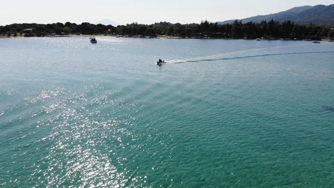 Flying low and intercepting a boat in a blue turquoise water lagoon Stock Footage 91969366