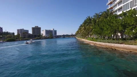 Flying in a low angle over a canal in Boca Raton Florida Stock Footage 168673545