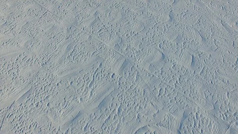 Flying low to the ground over a snow covered field 스톡 동영상 87477075