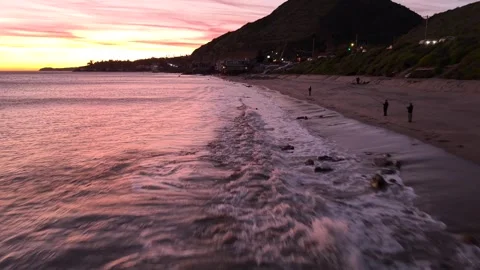 Flying Low to high above waves in Malibu CA. Pacific Ocean to PCH Highway 1 Stock Footage 334946109