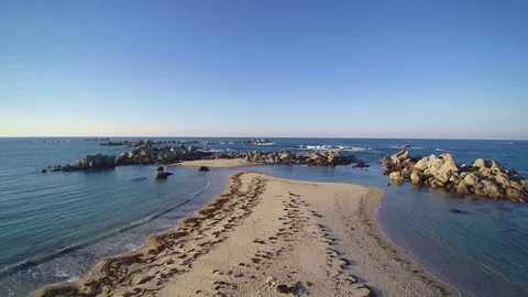 Flying low over a coastal tip in a sunny evening. 4K clip - 2 of 3. Stock Footage 86469249