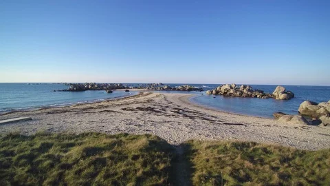 Flying low over a coastal tip in a sunny evening. 4K clip - 1 of 3. Stock Footage 86469863