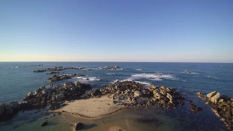 Flying low over a coastal tip in a sunny evening. 4K clip - 3 of 3. Stock Footage 86469894