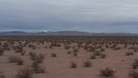 Flying low over the desert on a cloudy day Stock Footage 105550419