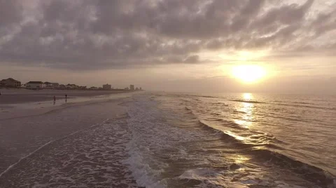 Flying Low Over The Ocean During a Sunrise Stock Footage