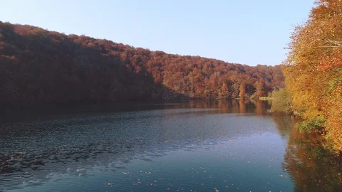 Flying low over Plitvice lakes national park on a sunny autumn day Stock Footage 97668950