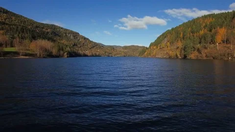 Flying low over rippled water towards mountains. Stock Footage 81216964
