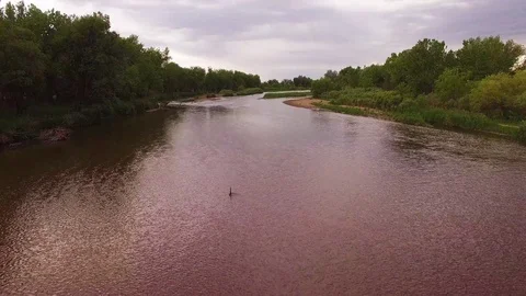 Flying Low Over River Downstream to Bridge Color Corrected Stock Footage 98846243