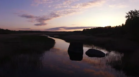 Flying low over river during sunset Stock Footage 64044601
