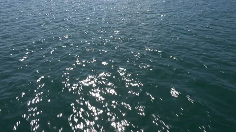 Flying low over water, sun glints in water Video stock 47415795