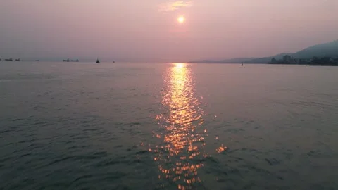 Flying low over water into sunset 動画素材 248481962
