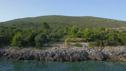 Flying low over water towards coast line Stock Footage 78005298