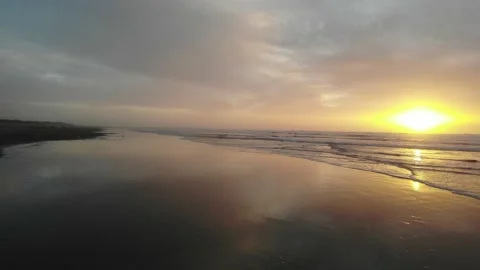 Flying Low Over Wet Beach into Sunset Video stock 145038020