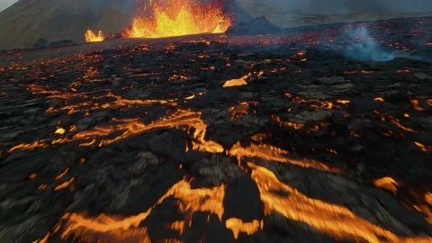 Flying low through an exploding Volcano magma cone - dramatic FPV drone Stock Footage 220048047