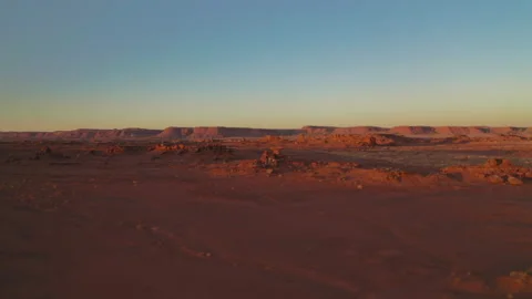 Flying low toward sunset over rocky desert landscape Stock Footage 147964294