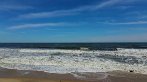 Flying a Mavic air 2 drone over a beach on a sunny Day of May Video stock 130588858