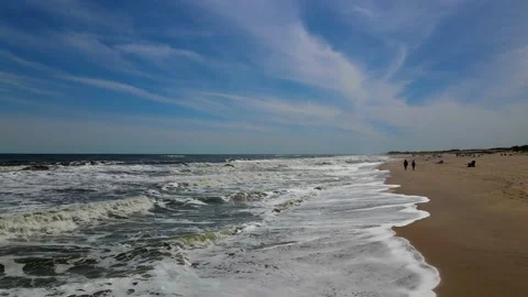Flying a Mavic air 2 drone over a beach on a sunny Day of May Stock Footage 130588953