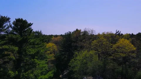 Flying a Mavic air 2 drone over a house on a sunny Day of May Stock Footage 130589253