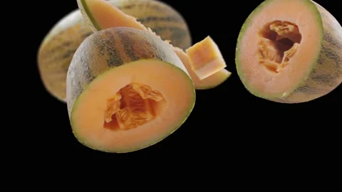 Flying Melon and Melons slices in Black Background Video stock 229558886
