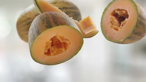 Flying Melon and Melons slices in Bright Kitchen Background Stock Footage 229560270