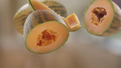 Flying Melon and Melons slices in Bright Brown Kitchen Background Stock Footage 229562153