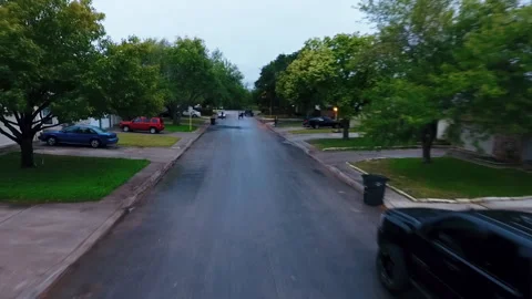 Flying in the middle of the street, Flying Through Suburban/Urban Neighborhood Stock Footage 212301833